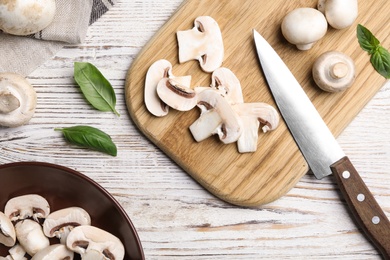Photo of Flat lay composition with fresh raw mushrooms on wooden table