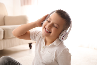 Photo of Little boy listening to music at home