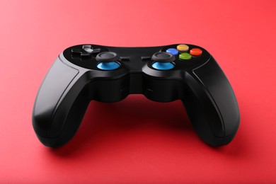 One wireless game controller on red background