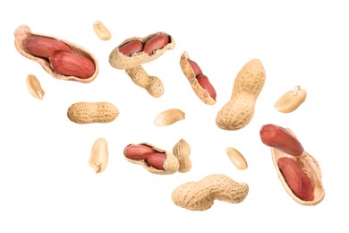 Image of Unpeeled peanuts in air on white background