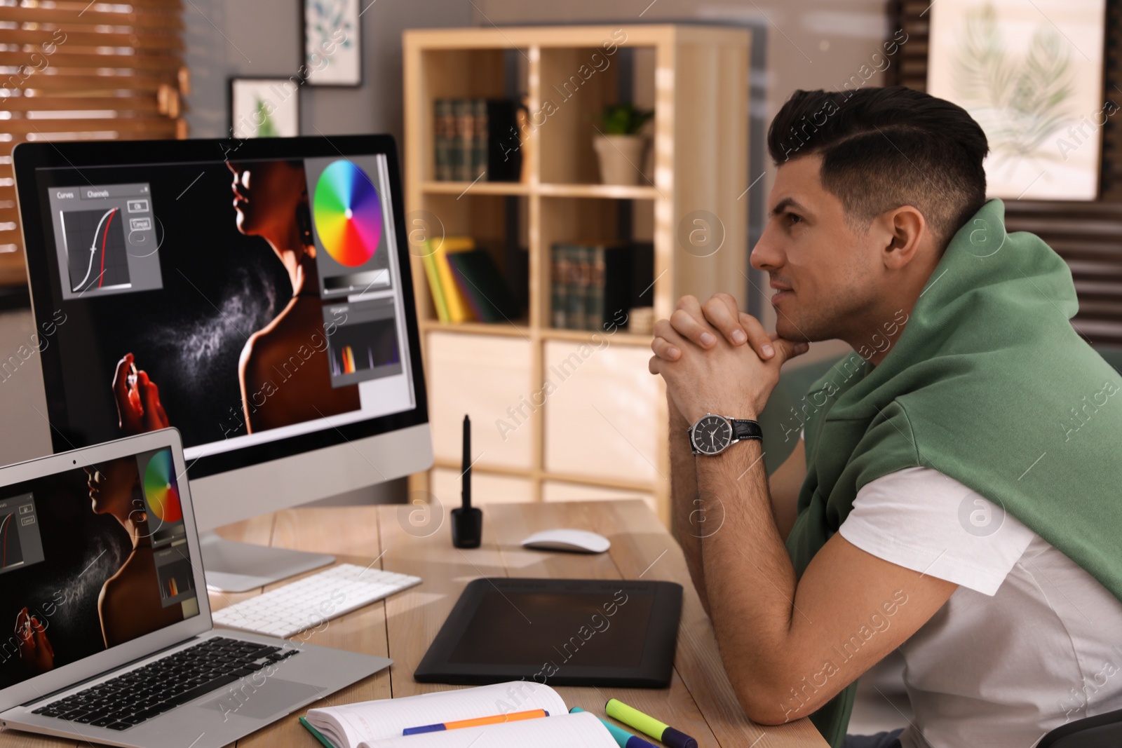 Photo of Professional retoucher working on computer in office