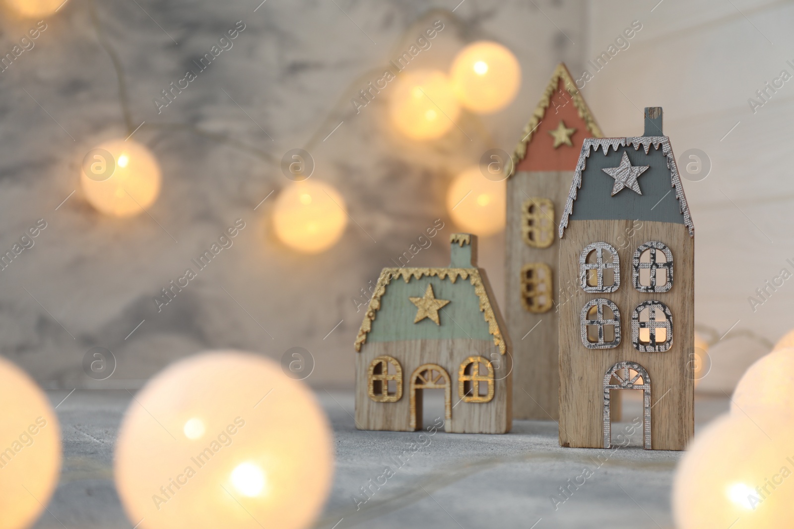 Photo of Christmas decor on table against light background. Space for text