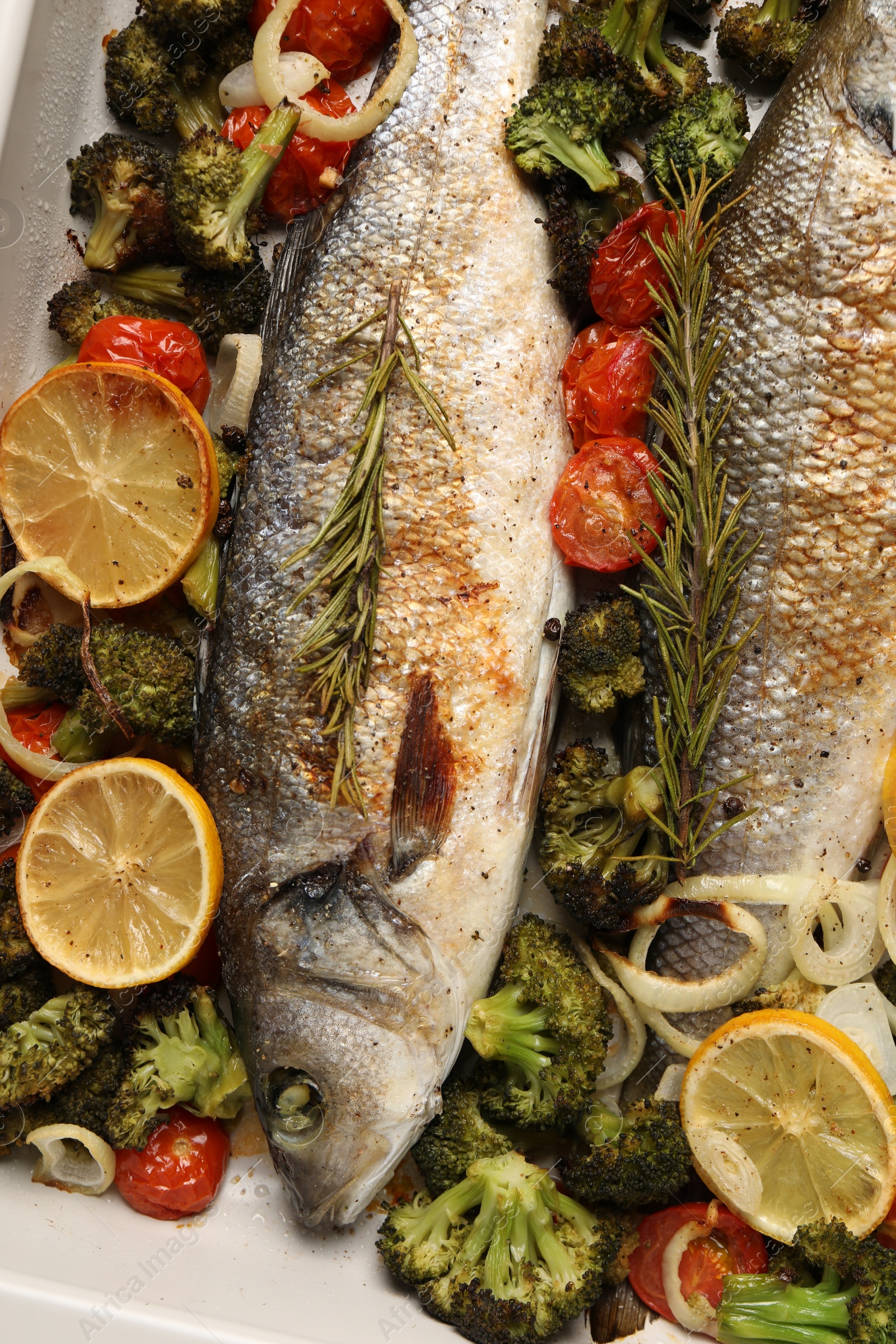 Photo of Delicious fish with vegetables and lemon in baking dish, flat lay