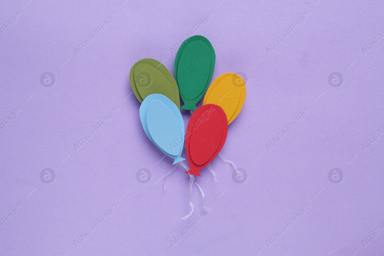 Photo of Birthday party. Paper colorful air balloons on lilac background, top view