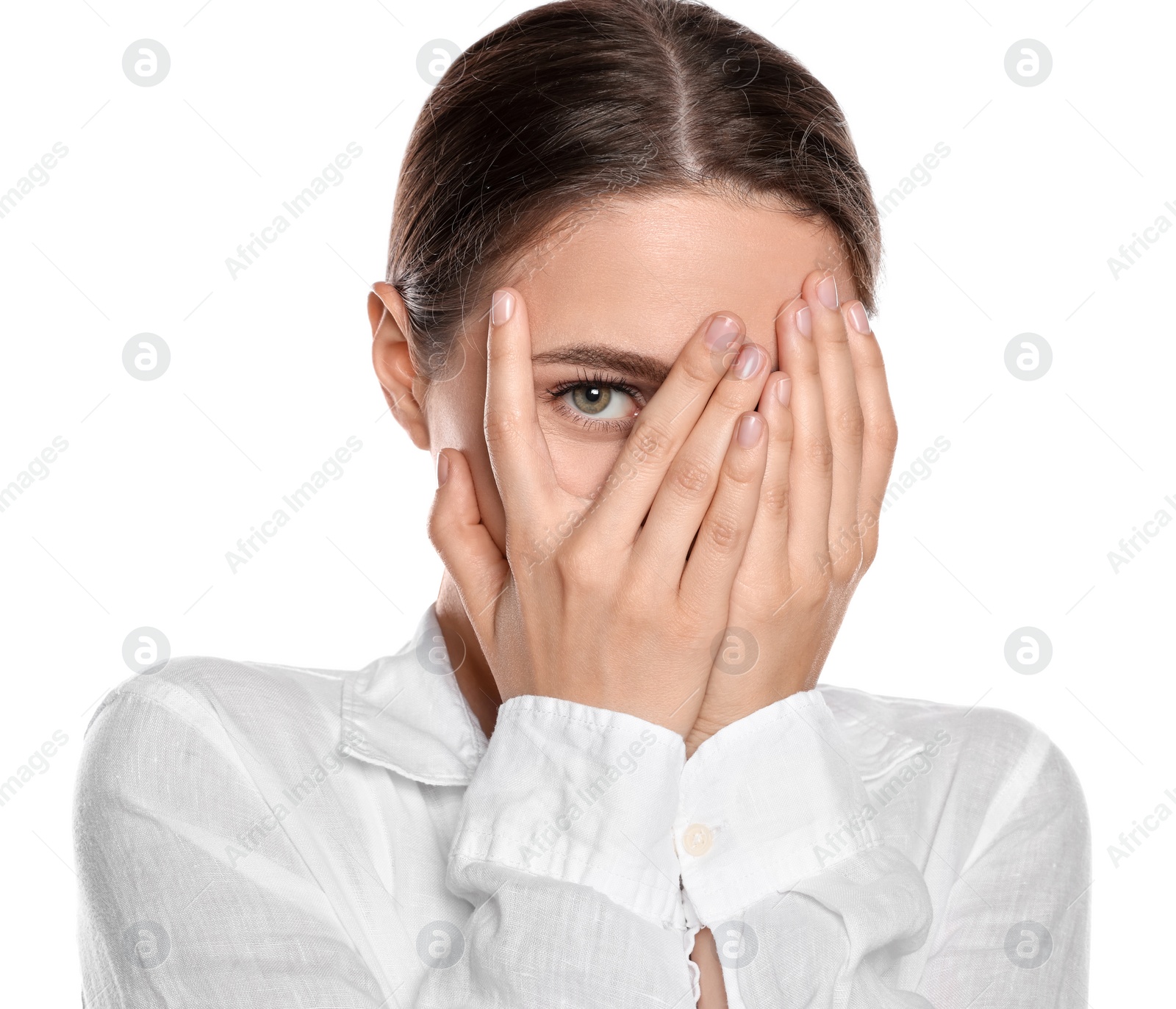 Photo of Embarrassed young woman covering face with hands on white background