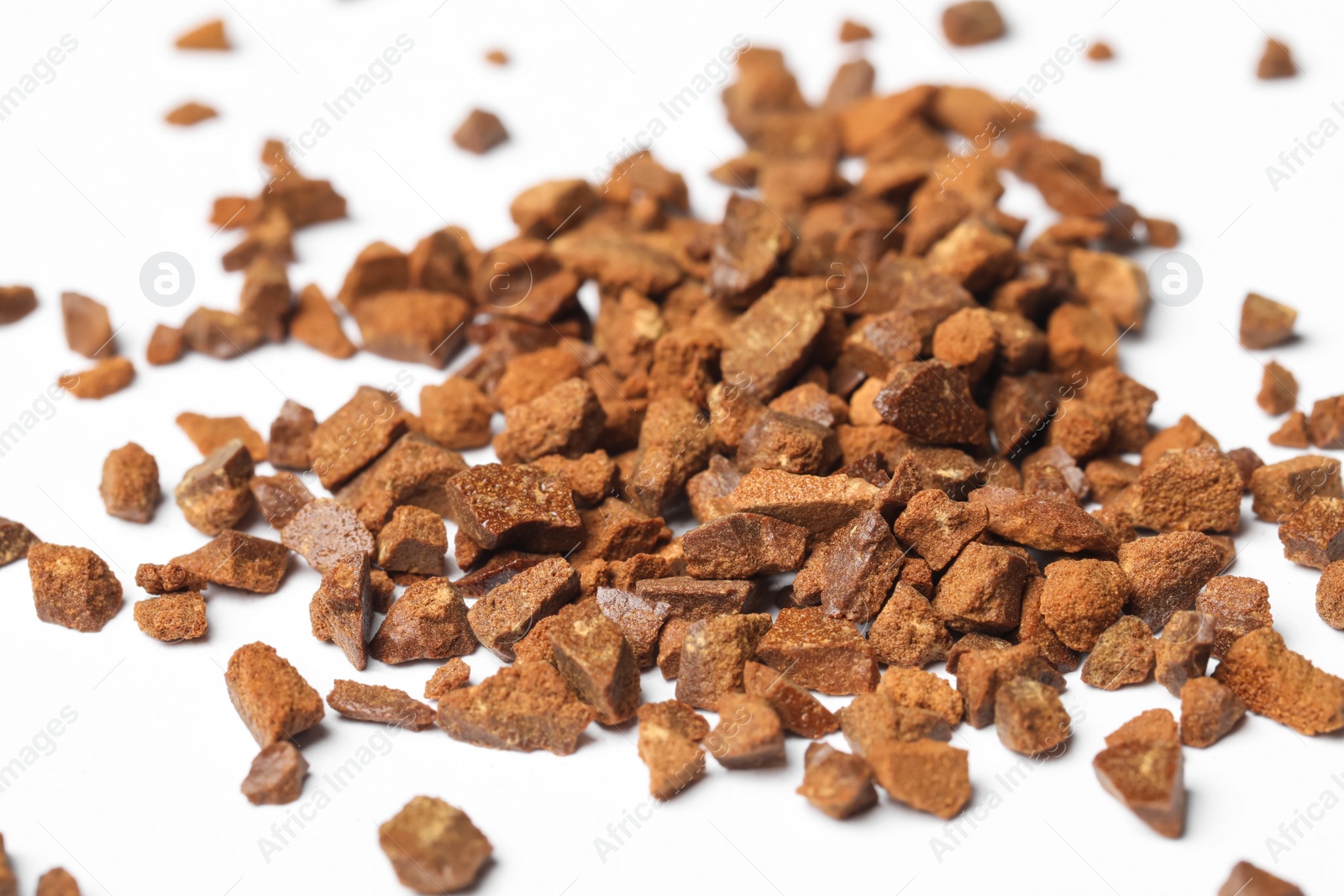 Photo of Pile of chicory granules on white background, closeup