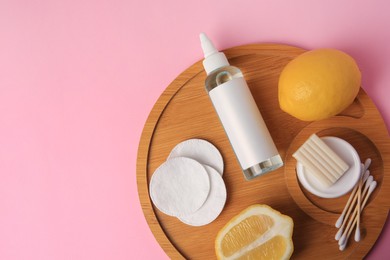 Lemon face cleanser. Fresh citrus fruits and personal care products on pink background, top view. Space for text