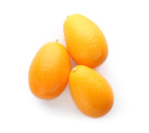 Photo of Fresh ripe kumquats on white background, top view. Exotic fruit