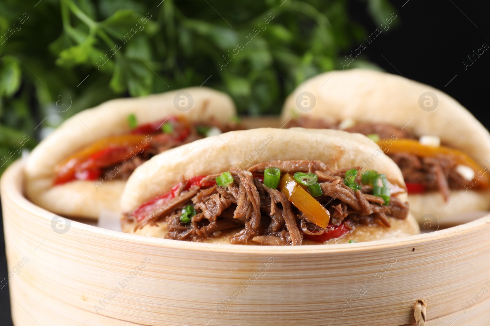 Photo of Delicious gua bao in bamboo steamer, closeup