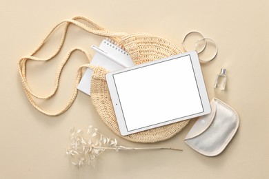 Flat lay composition with modern tablet on beige background. Space for text