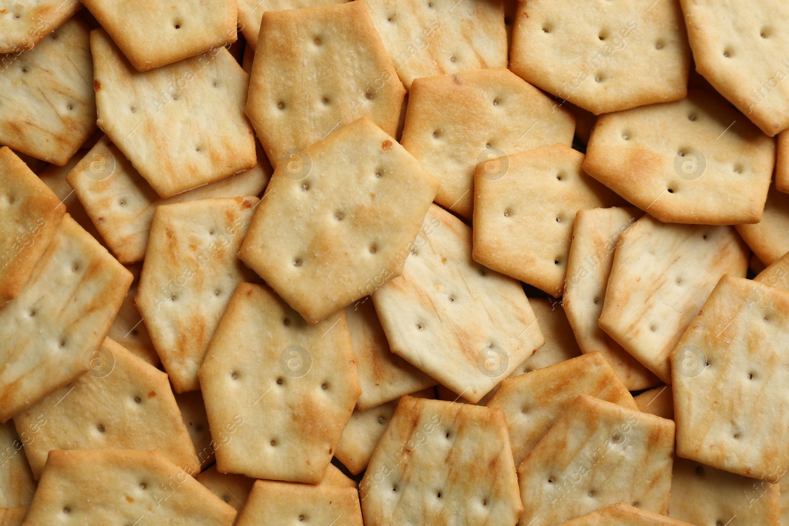 Photo of Many delicious crackers as background, top view