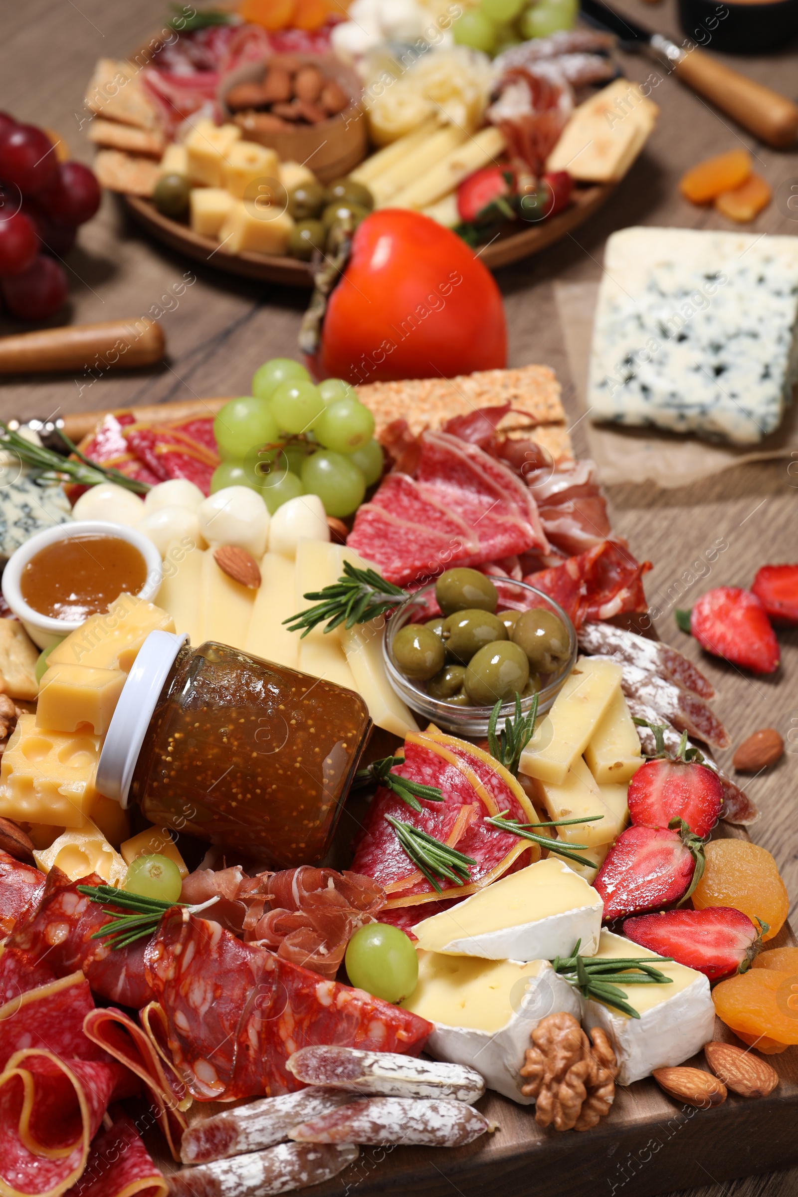 Photo of Many different appetizers served on wooden table