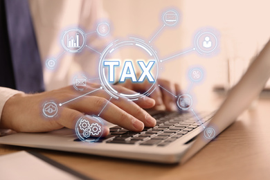 Tax concept. Scheme with icons and man using laptop on background