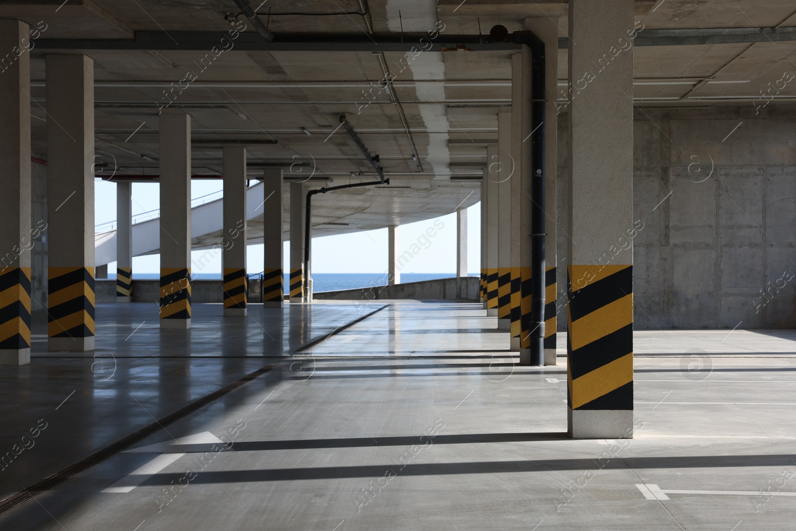 Photo of Empty open car parking garage on sunny day