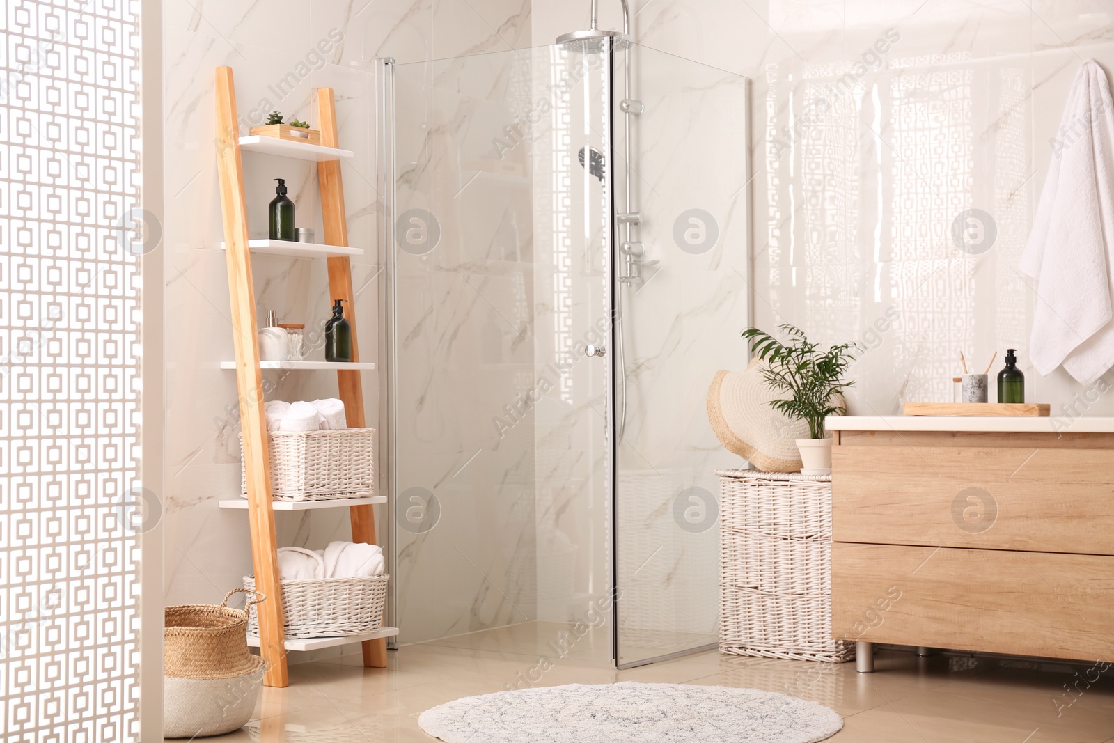 Photo of Modern bathroom interior with decorative ladder and shower stall