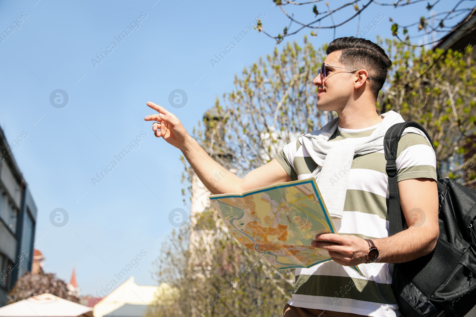 Photo of Tourist with map walking on city street