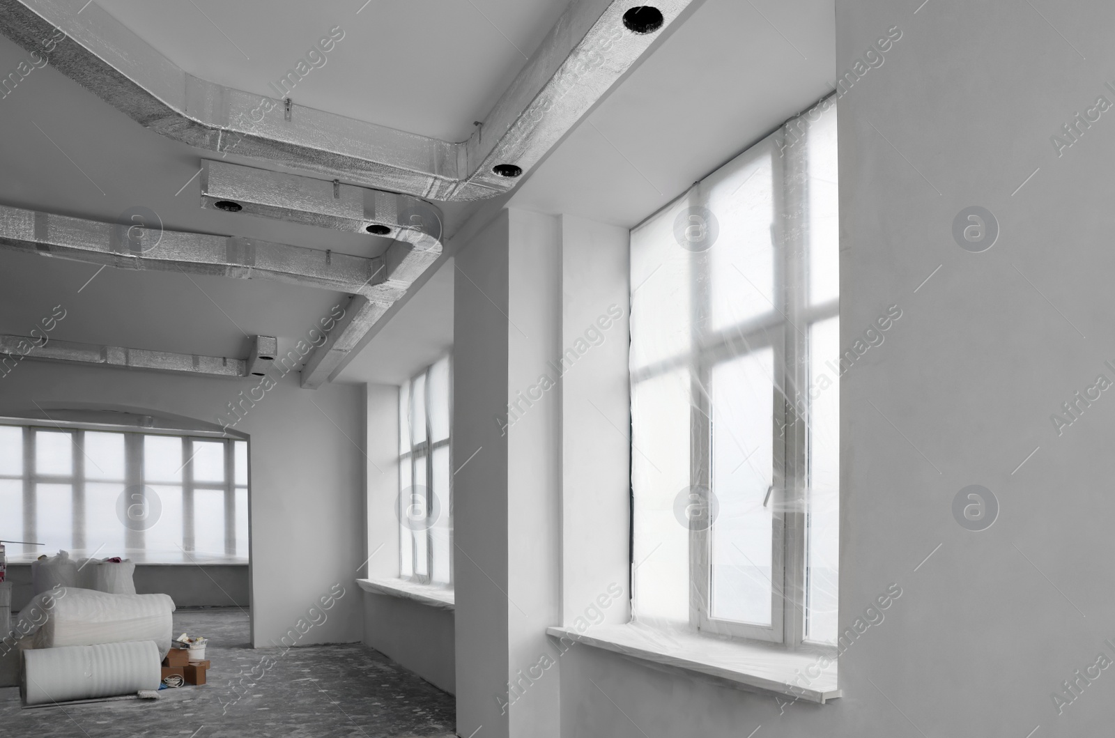 Photo of Windows covered with plastic film in spacious room