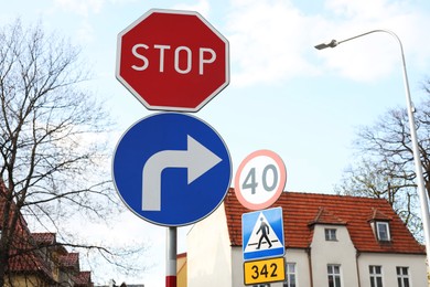 Different traffic signs on city street, space for text