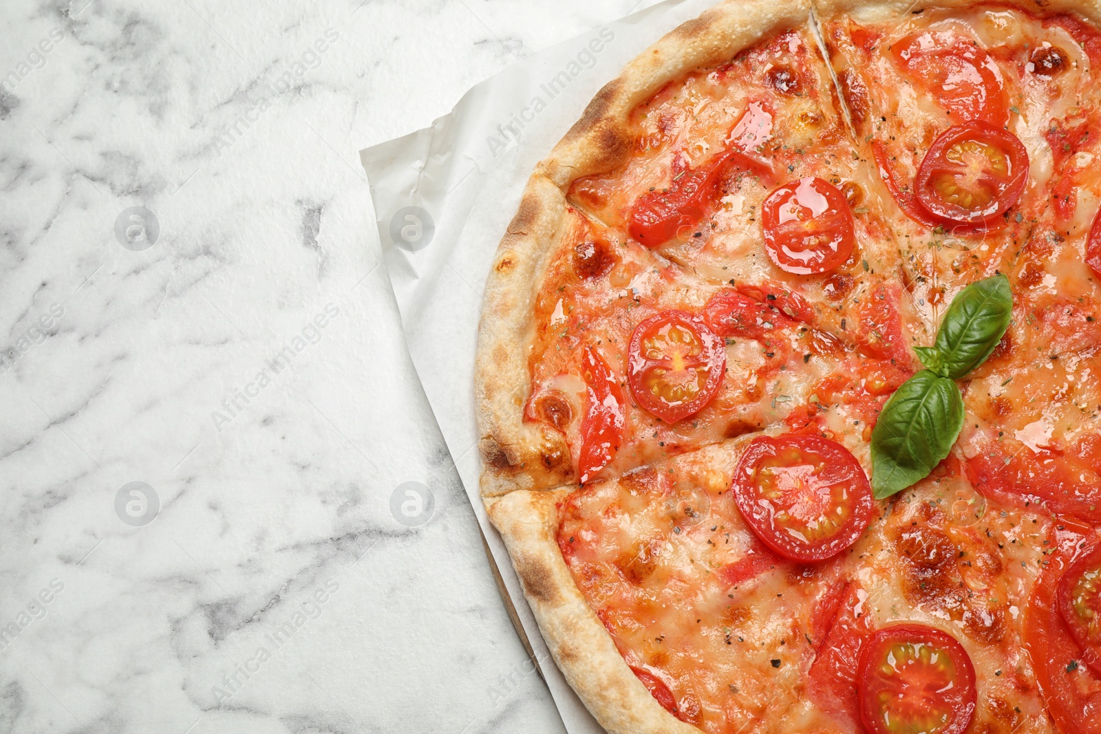 Photo of Delicious pizza Margherita on white marble table, top view. Space for text