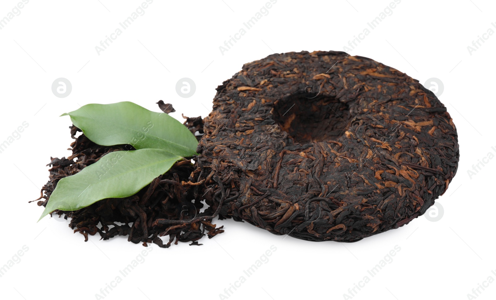 Photo of Broken disc shaped traditional Chinese pu-erh tea and fresh leaves isolated on white