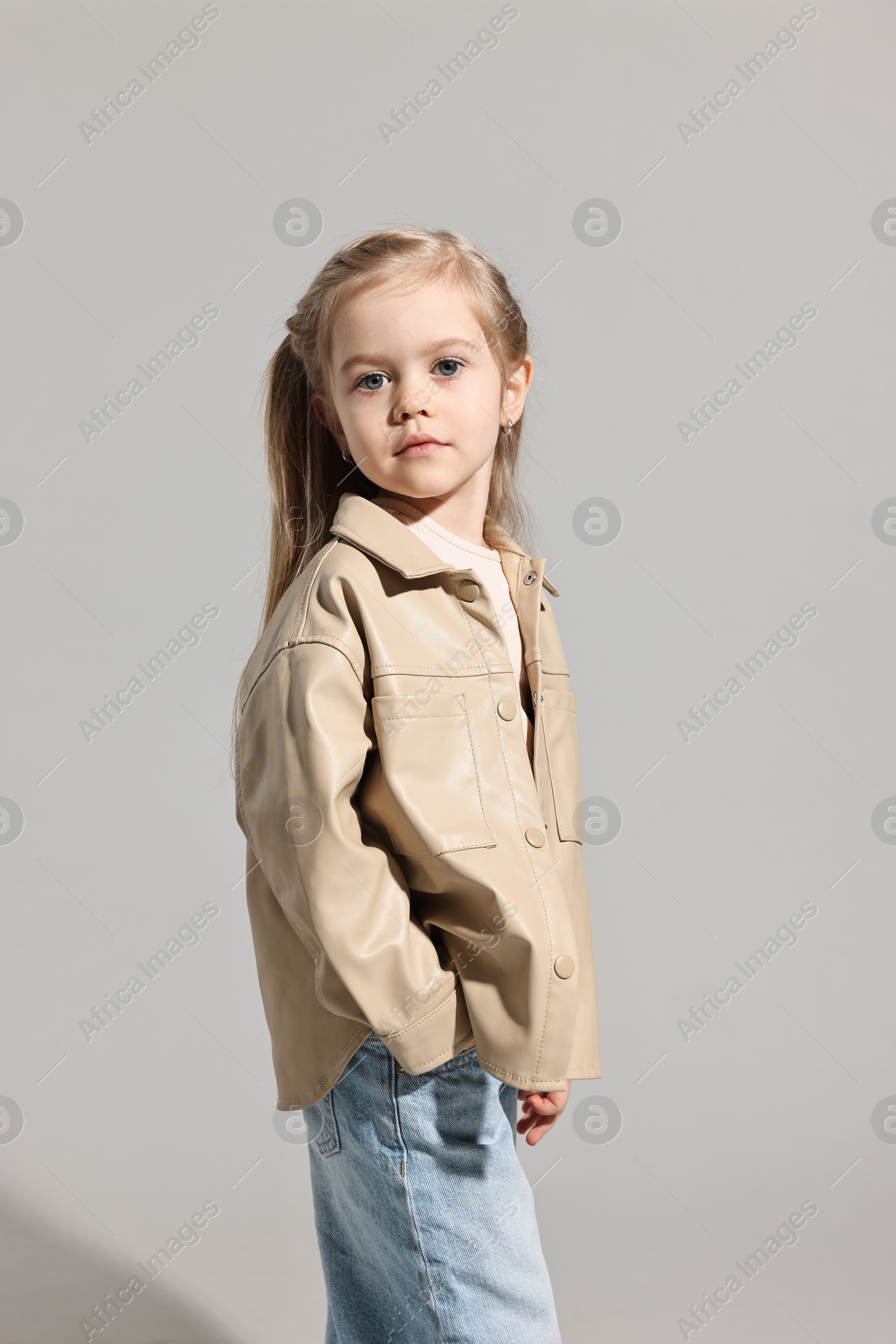 Photo of Fashion concept. Stylish girl posing on light grey background