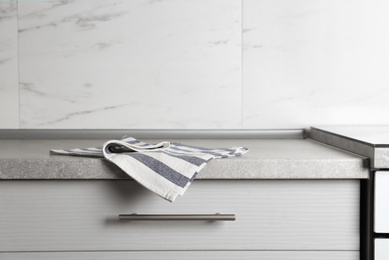 Striped cotton towel on countertop in kitchen