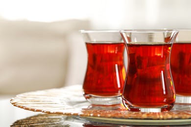 Glasses with traditional Turkish tea on table indoors, closeup. Space for text
