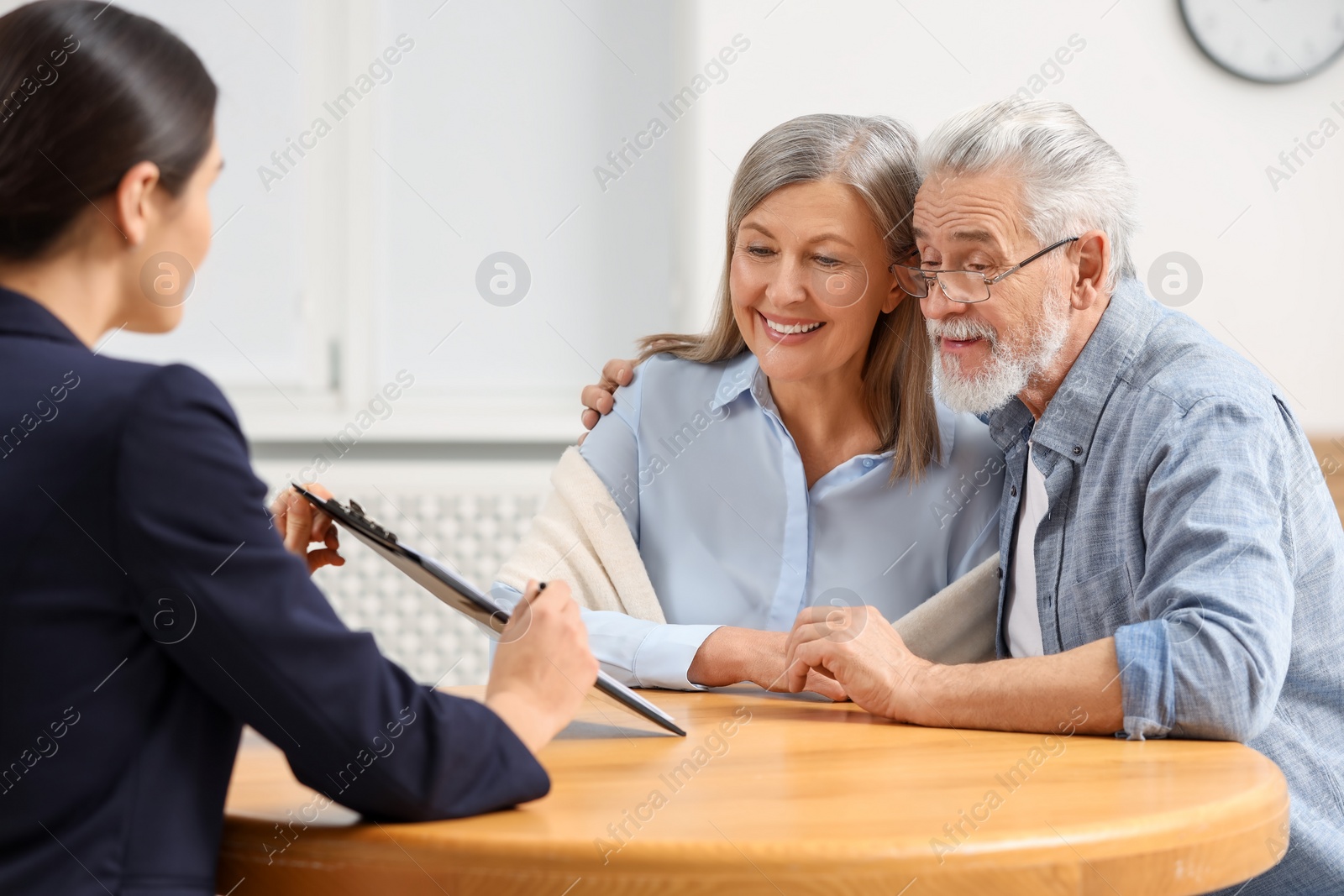 Photo of Notary consulting senior couple about Last Will and Testament in office