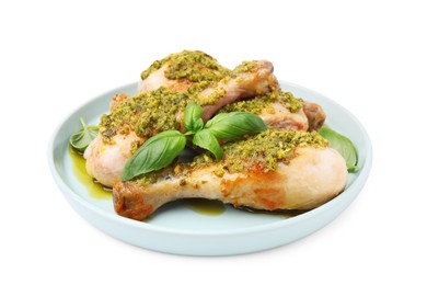 Photo of Delicious fried chicken drumsticks with pesto sauce and basil isolated on white