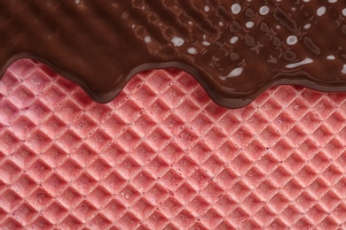 Photo of Hot dark chocolate on wafer, closeup. Crispy food