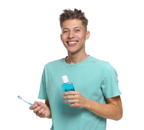 Photo of Young man with mouthwash and toothbrush on white background