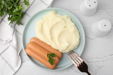 Photo of Delicious boiled sausages, mashed potato, parsley and fork on white textured table, flat lay