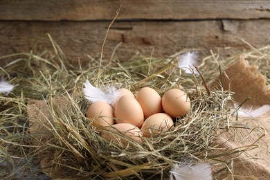 Fresh raw chicken eggs in nest on table