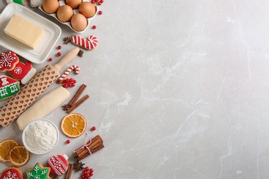 Photo of Flat lay composition with homemade Christmas cookies and ingredients on grey table, space for text