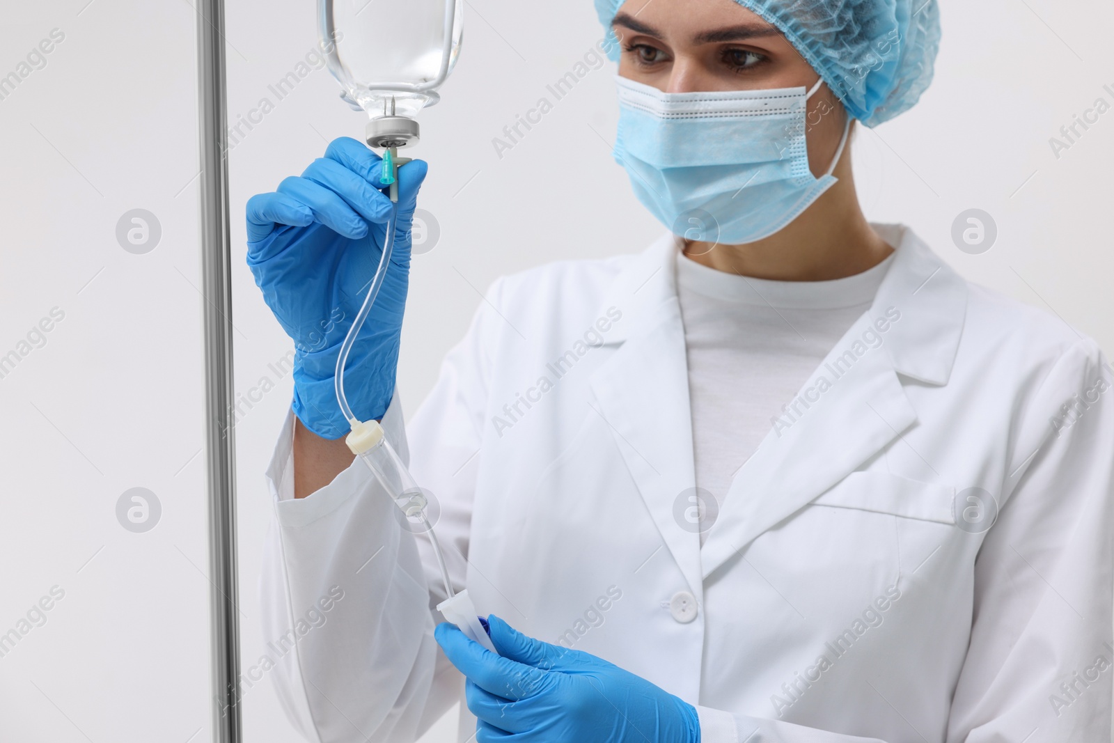 Photo of Nurse setting up IV drip in hospital, closeup