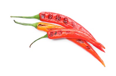 Photo of Tasty grilled chili peppers isolated on white, top view