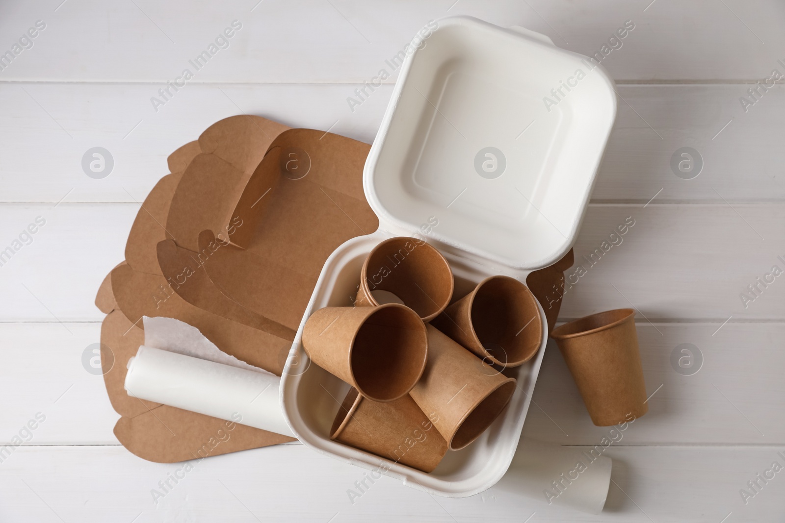 Photo of Heap of waste paper on white wooden table, flat lay