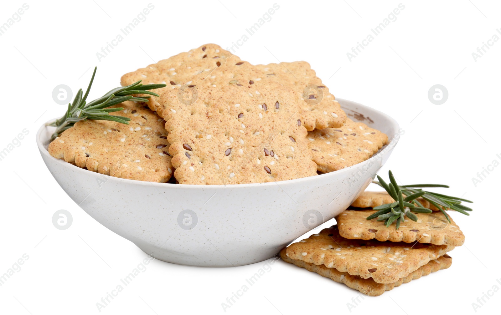Photo of Cereal crackers with flax, sesame seeds and rosemary in bowl isolated on white
