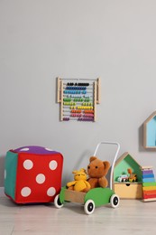 Beautiful children's room with grey wall and toys. Interior design