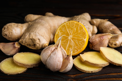 Photo of Fresh garlic and other natural cold remedies on wooden table