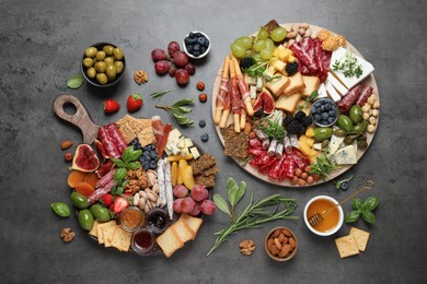 Different tasty appetizers on dark grey table, flat lay