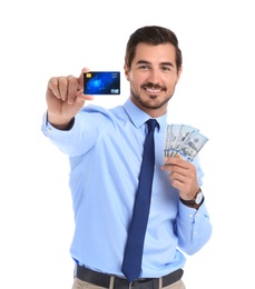 Handsome businessman with dollars and credit card on white background