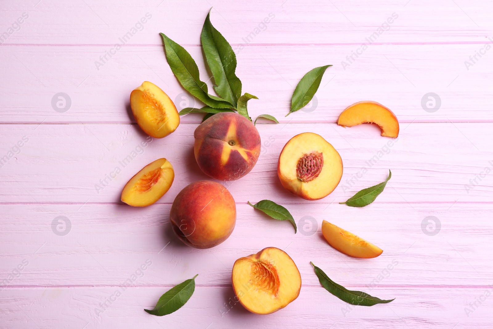 Photo of Fresh sweet peaches on pink wooden table, flat lay