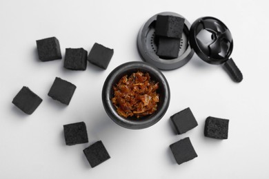 Photo of Hookah parts with tobacco and charcoals on white background, top view
