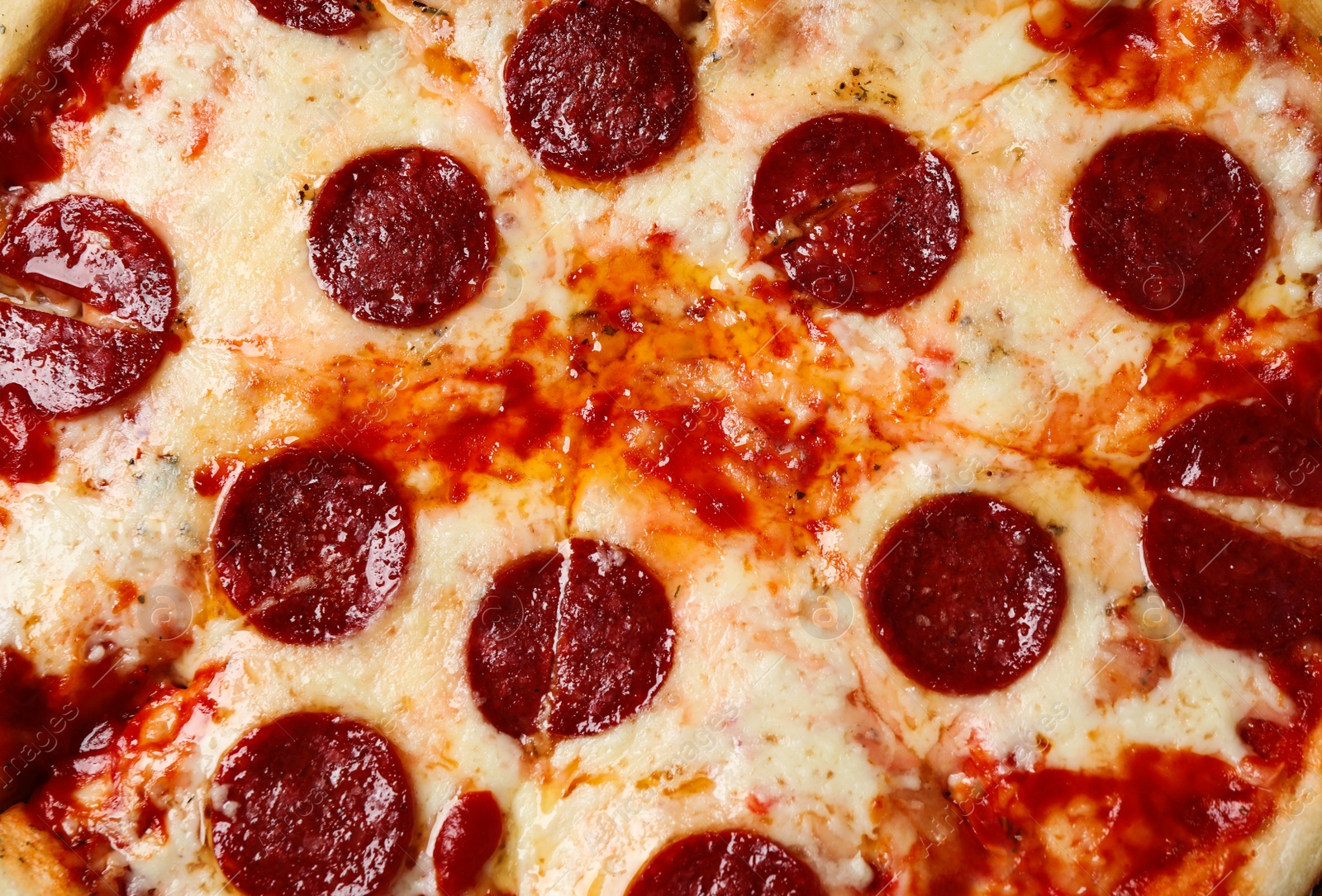 Photo of Hot delicious pepperoni pizza with melted cheese, closeup