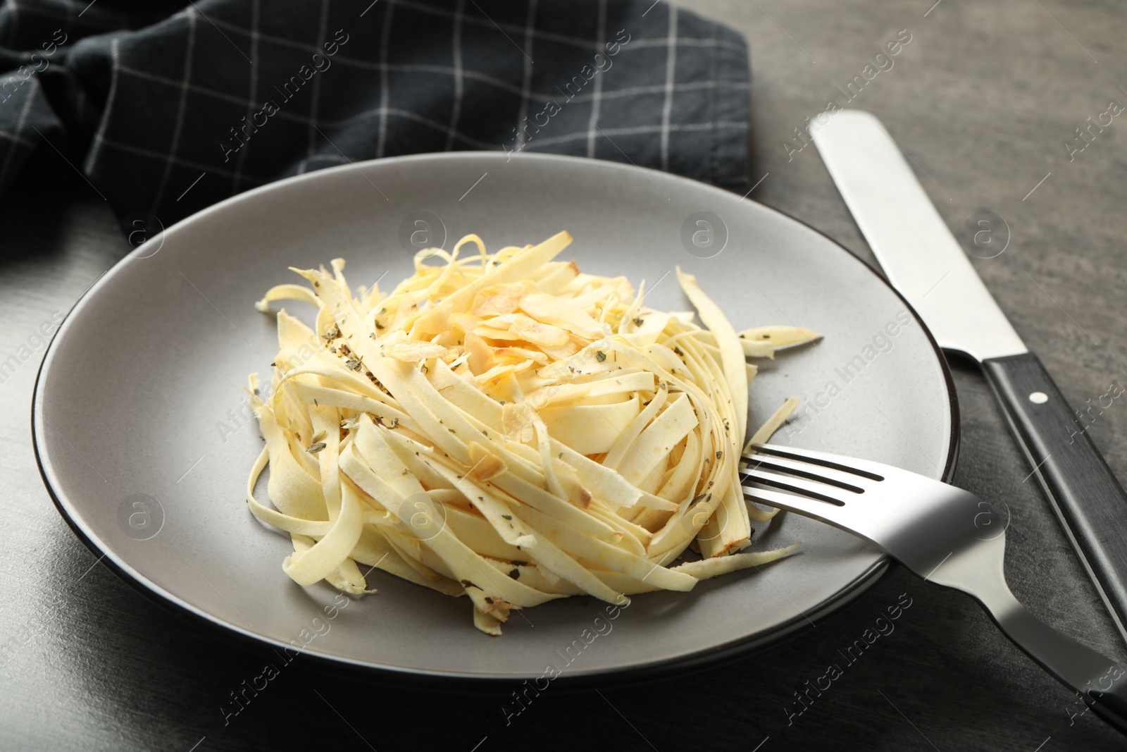 Photo of Fresh white carrot salad served on grey table, closeup