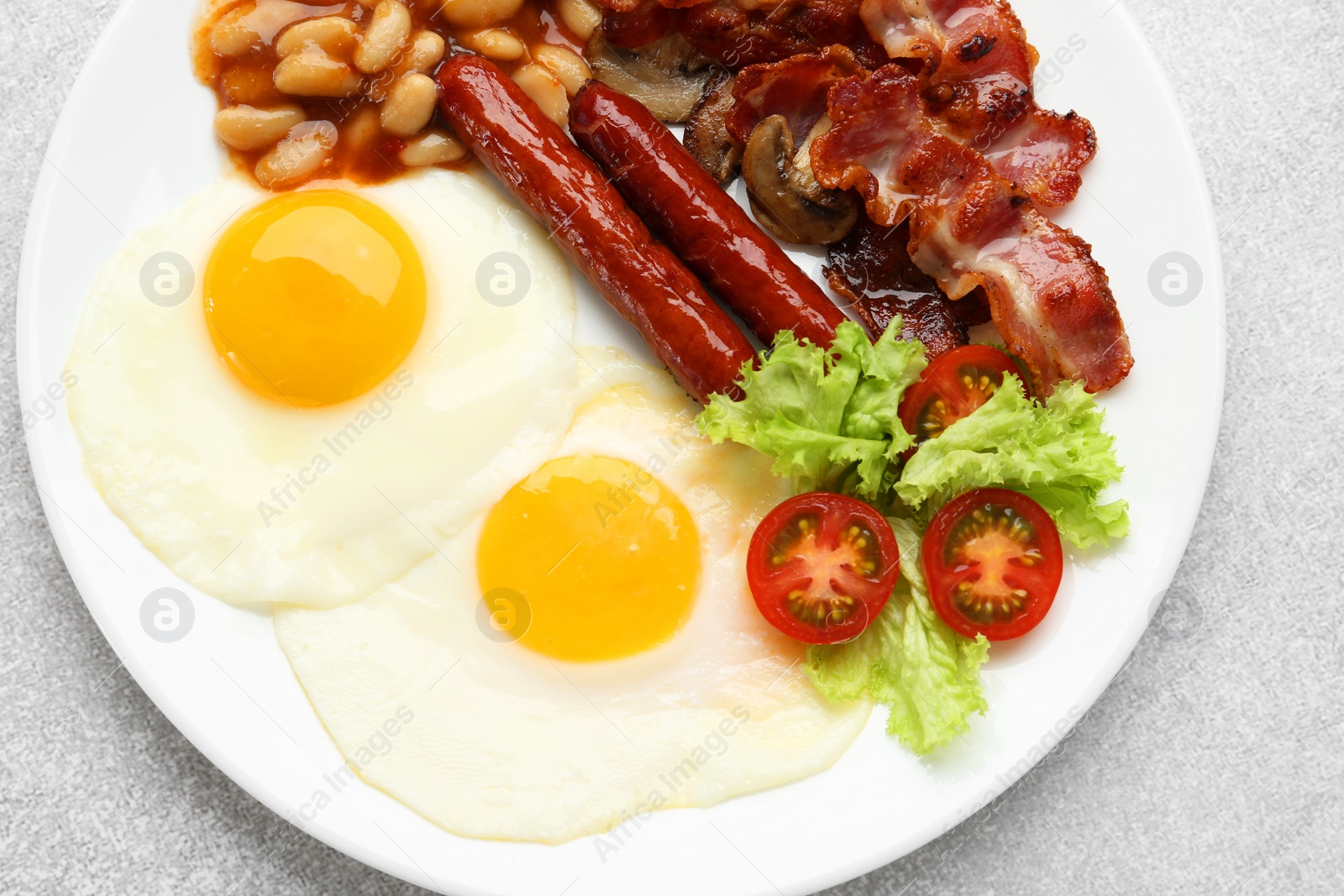 Photo of Delicious breakfast with sunny side up eggs on light table, top view
