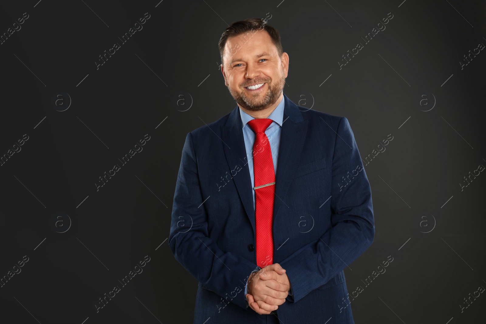 Photo of Portrait of happy mature man on black background