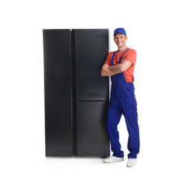 Photo of Male technician near refrigerator on white background