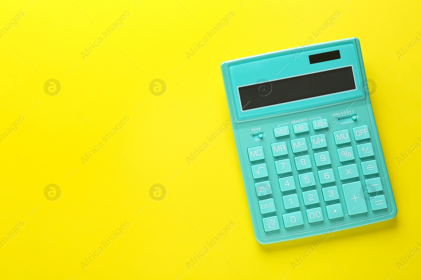 Photo of Modern calculator on yellow background, top view. Space for text